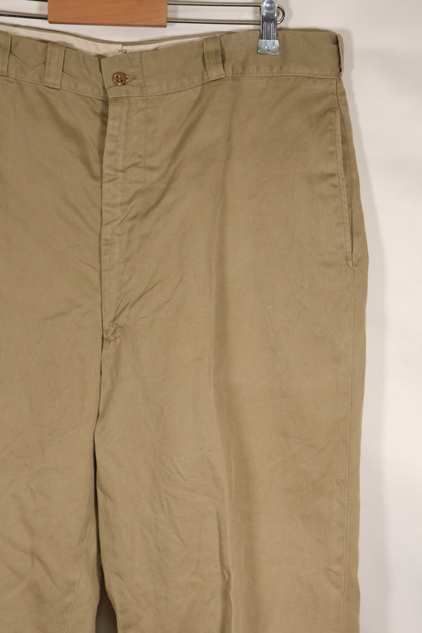 1960s, estimated 34-36 US Army cotton khaki pants, used.