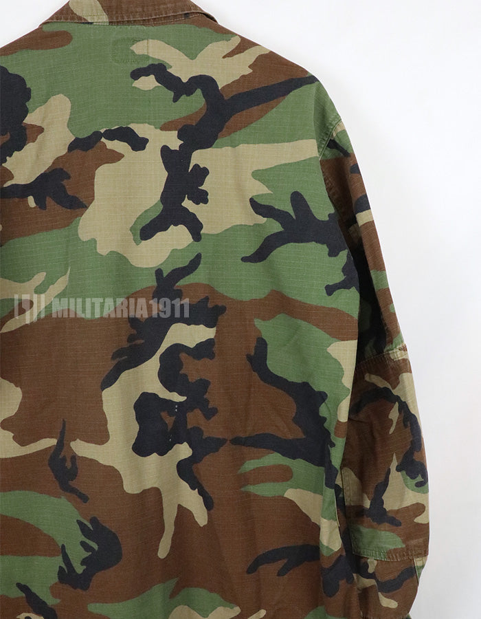 US SURPLUS U.S. Army Special Forces Woodland Camouflage Jacket, 1996, with patches.