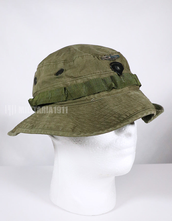 Real U.S. Army boonie hat with metal insignia, faded.