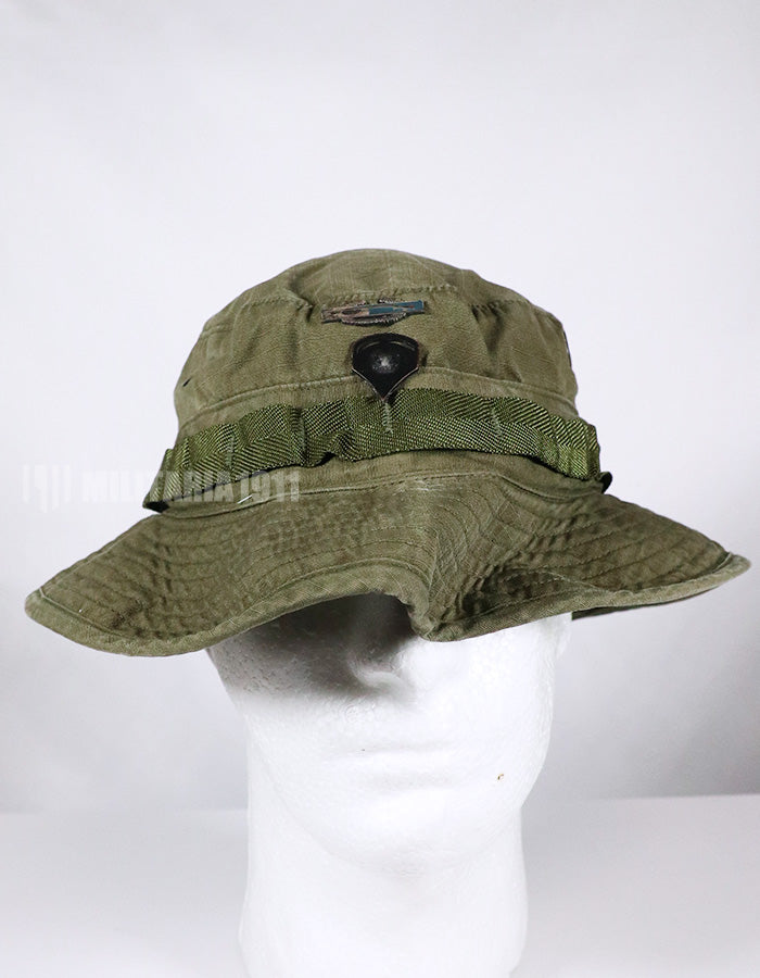 Real U.S. Army boonie hat with metal insignia, faded.