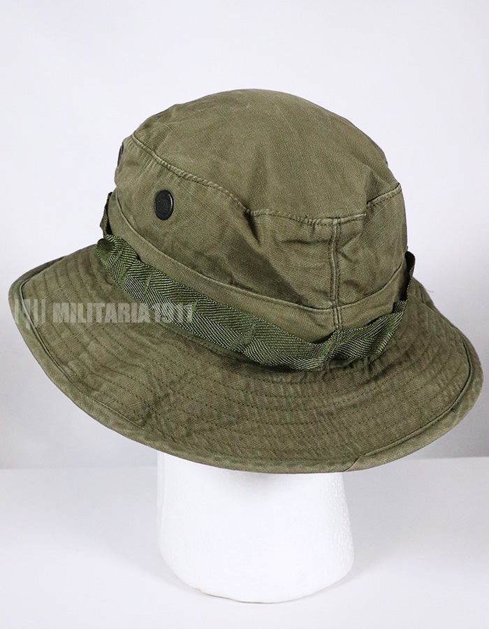 Real U.S. Army boonie hat with metal insignia, faded.