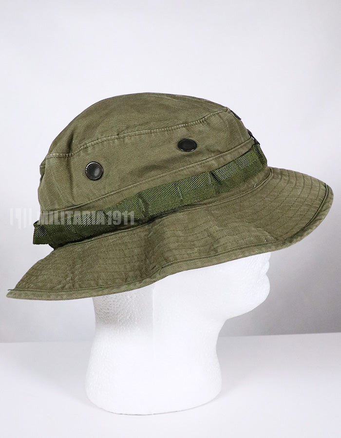 Real U.S. Army boonie hat with metal insignia, faded.